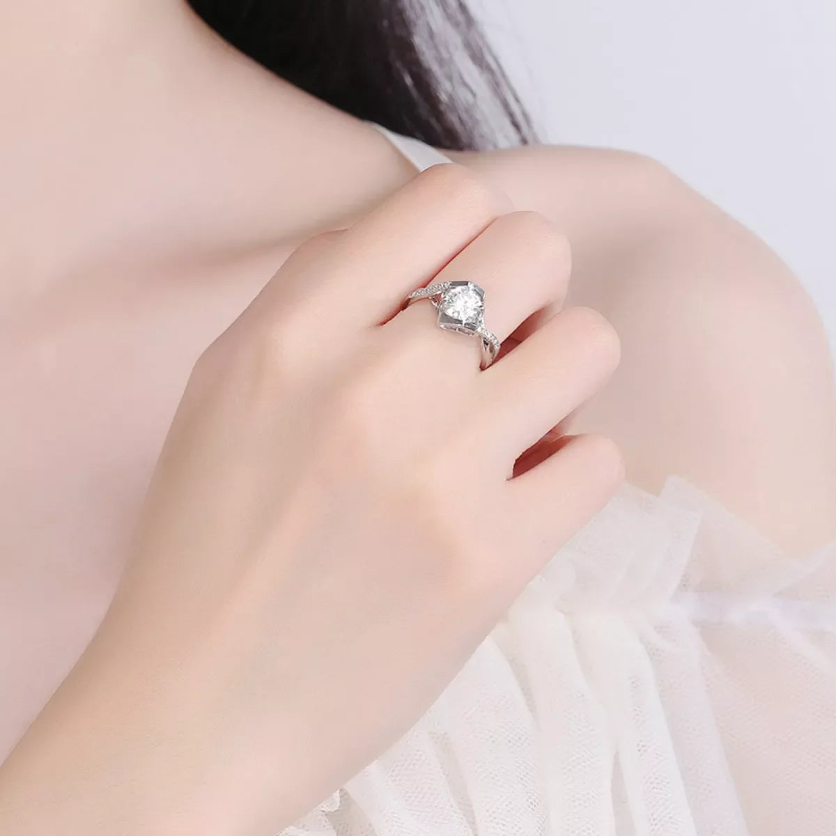 Sterling silver 1 carat moissanite ring with a sparkling central stone, elegant jewelry piece from Plush Fashion Hub.