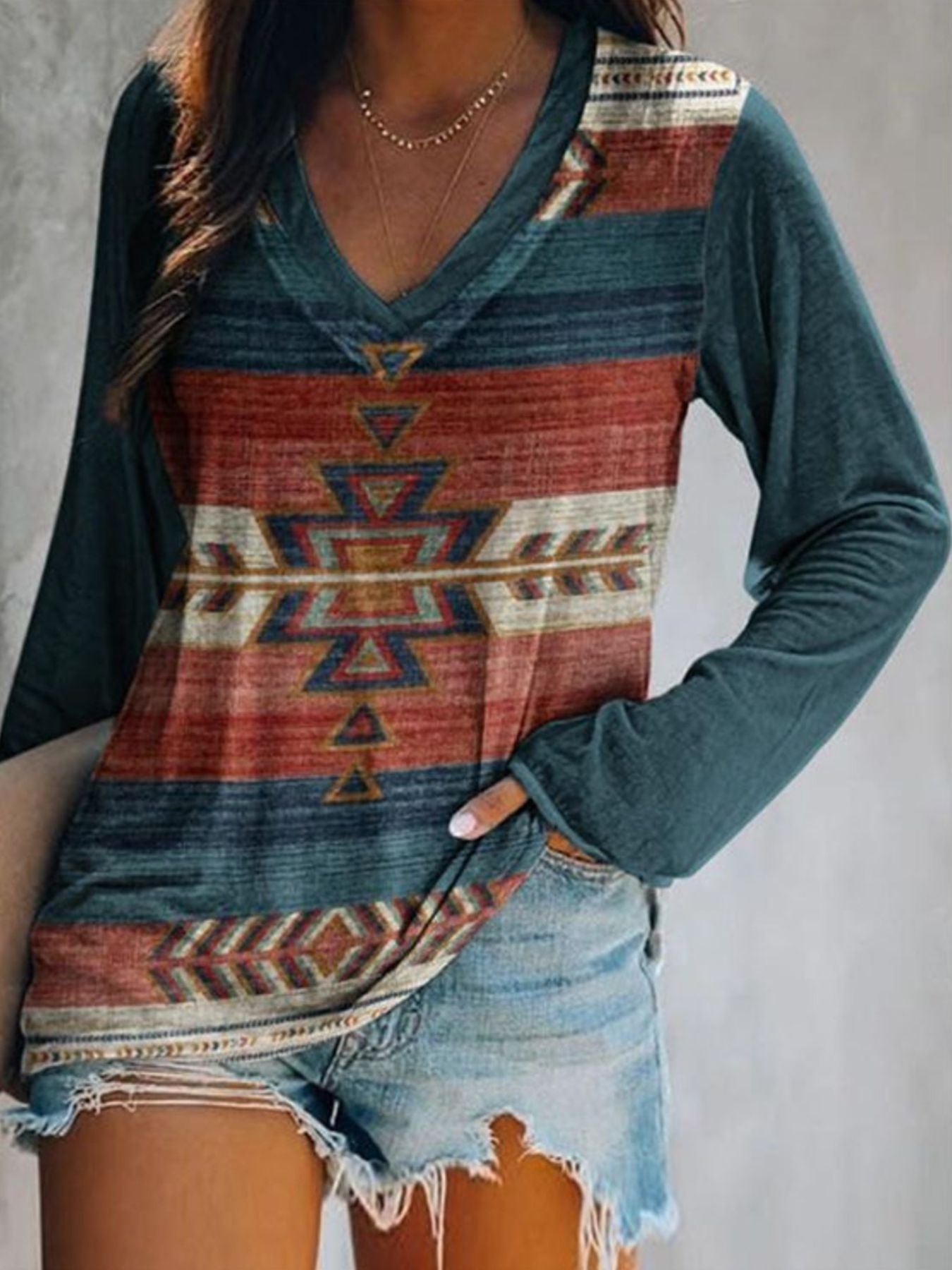 Plus size V-neck T-shirt with geometric print by Trendsi, featuring long sleeves and a comfortable casual fit.