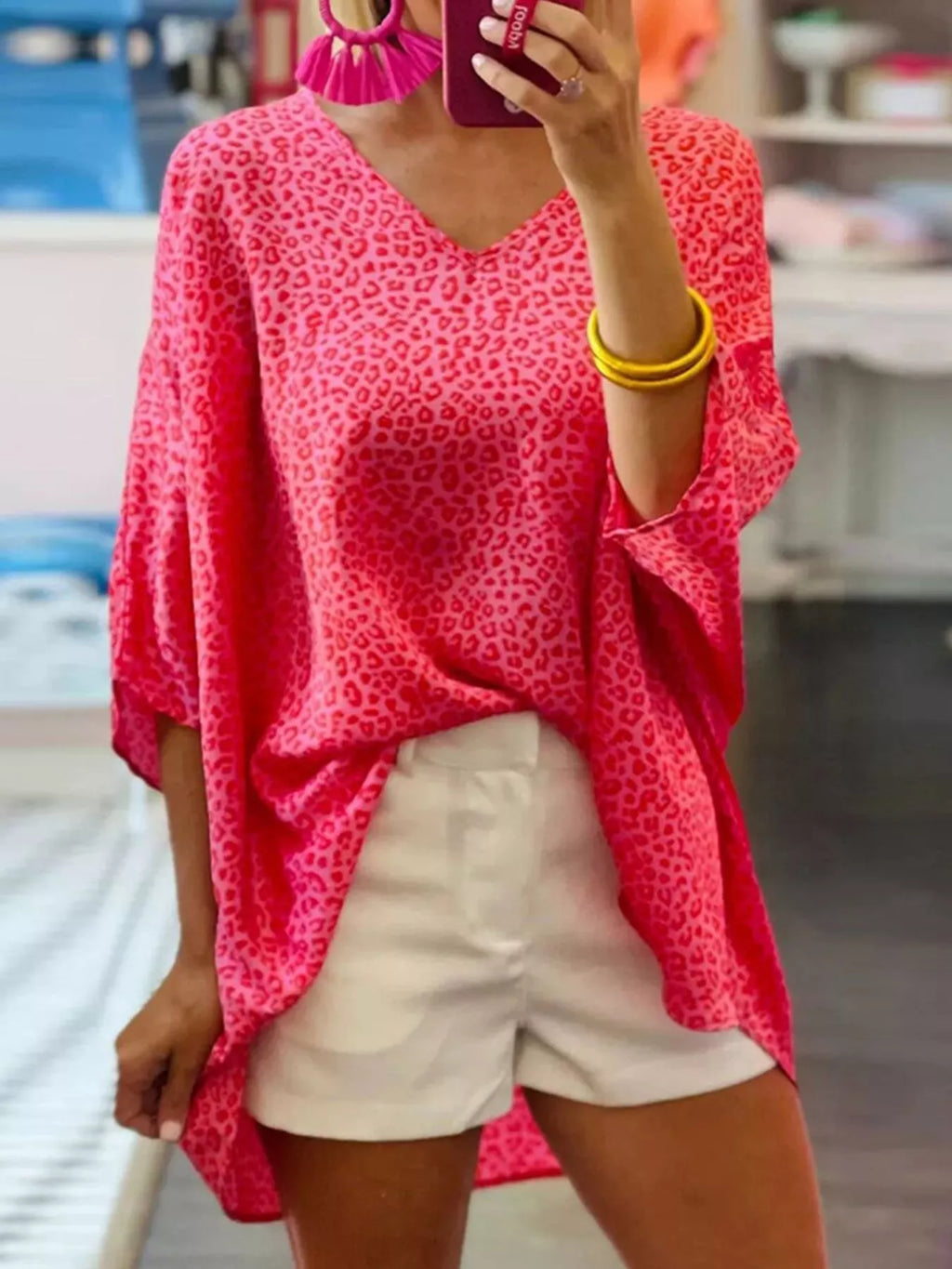 Women's leopard print V-neck blouse by Trendsi, short sleeve animal print top with trendy design and fitted silhouette.