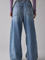 Women's relaxed fit cargo denim jeans with drawstring waist and utility pockets by Trendsi, shown from the front.
