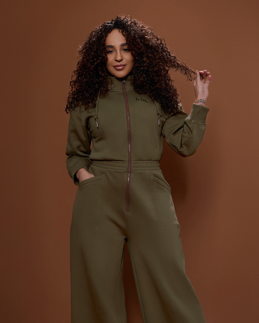 Green satin-lined jumpsuit by Plush Fashion Hub, featuring a stylish fit with long sleeves and a tapered leg silhouette.