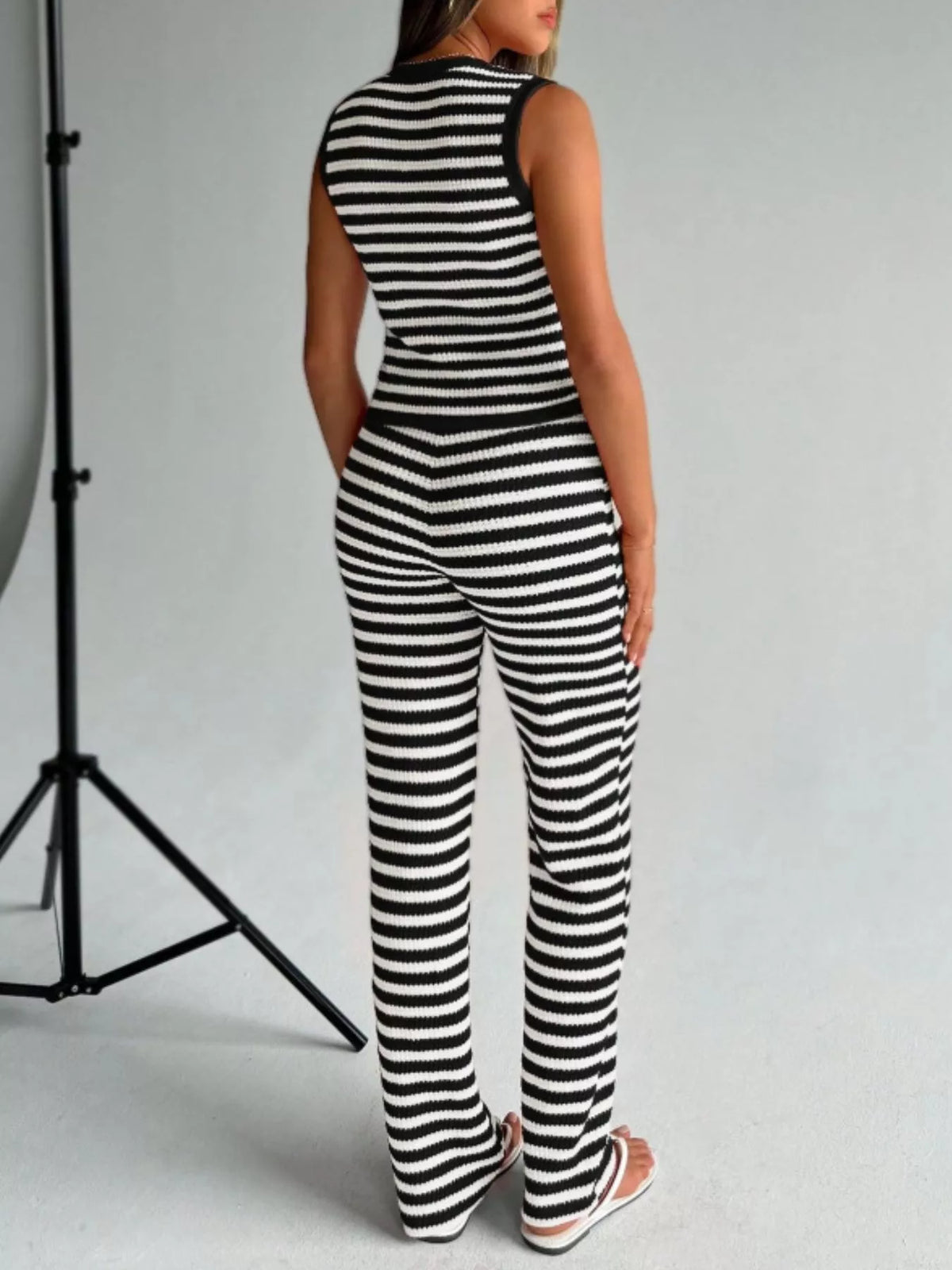 Striped knit V-neck sleeveless top and flare pants set by Plush Fashion Hub, featuring a stylish and comfortable casual outfit.
