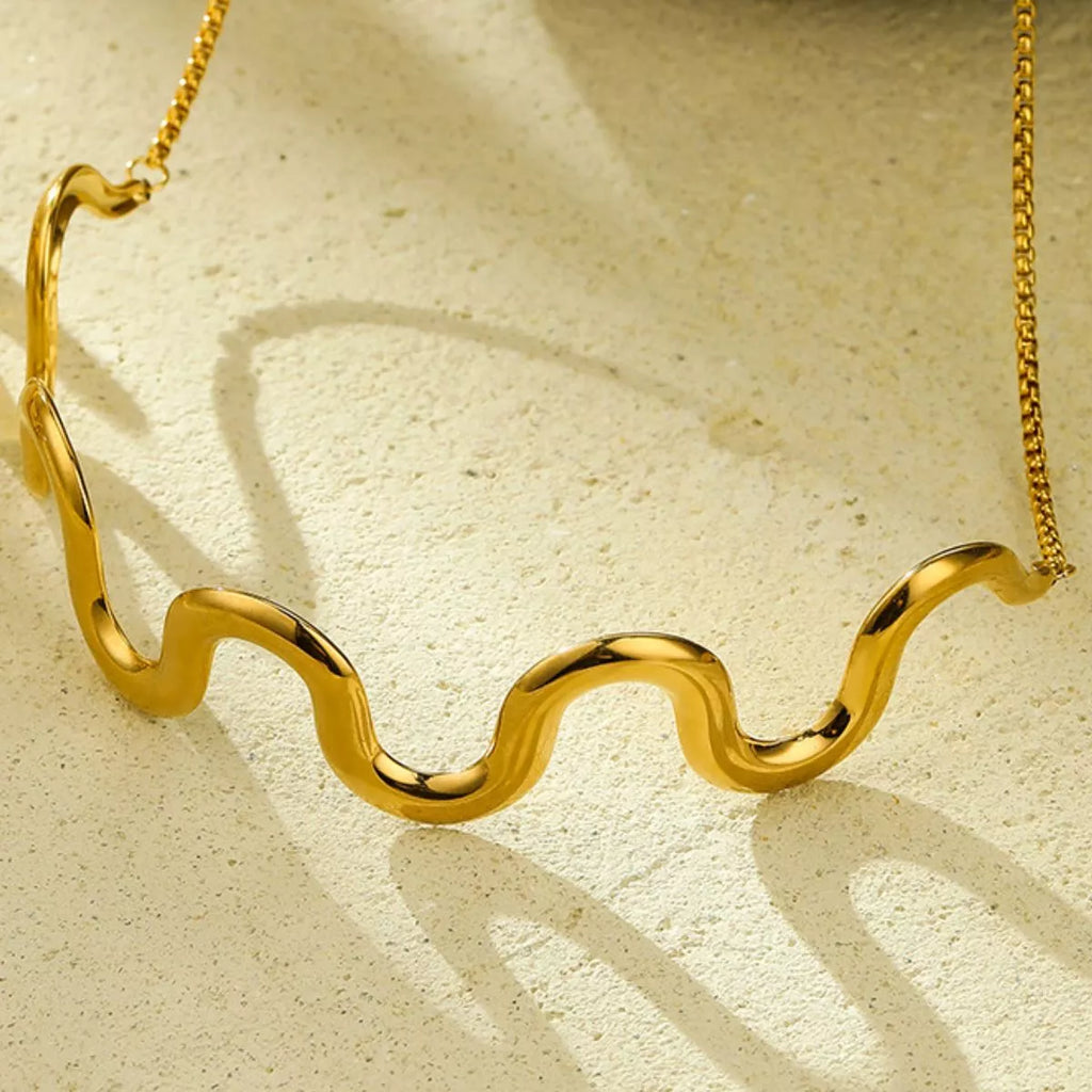 18K gold-plated wave necklace from Shopimist featuring a sleek, flowing ocean-inspired design on a delicate chain.