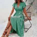 Flowy floral boho maxi dress with short sleeves and ruffle details, perfect for casual summer wear by FitiqueFit.