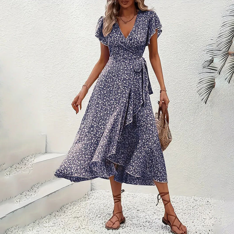 Flowy floral boho summer dress by FitiqueFit featuring short sleeves, ruffles, and a maxi length for casual wear.