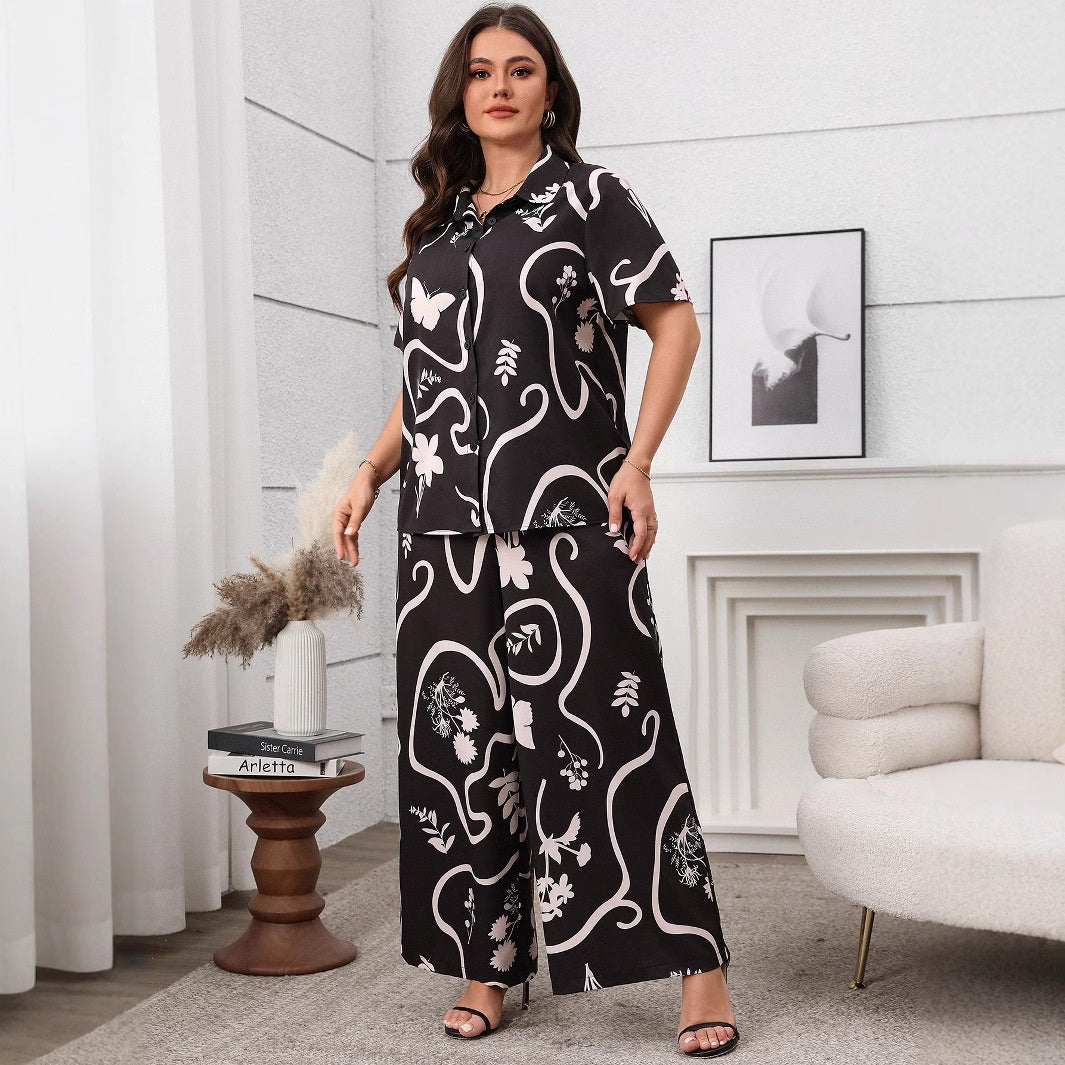 Black and white botanical pattern shirt and wide-leg trousers set with short sleeves, lapel collar, and buttons.