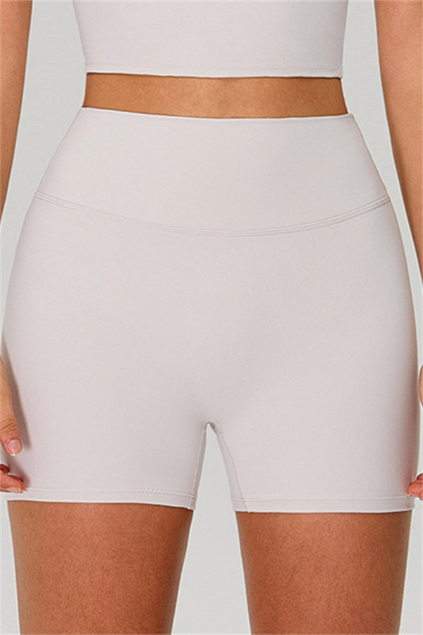 Fitglutes activewear one-shoulder crop top and shorts 2-piece set, gymwear and sportswear for workout and fitness activities.