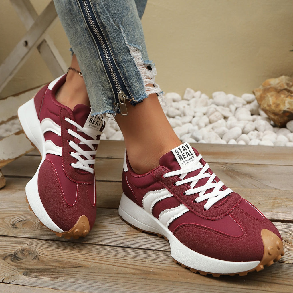 Women's round toe lace-up flat casual sneakers in comfortable PU leather, featuring a sleek design and neutral color.