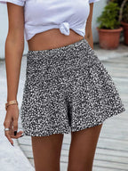 Floral print elastic waist shorts by Trendsi with vibrant flower patterns and comfortable fit, perfect for casual summer wear.