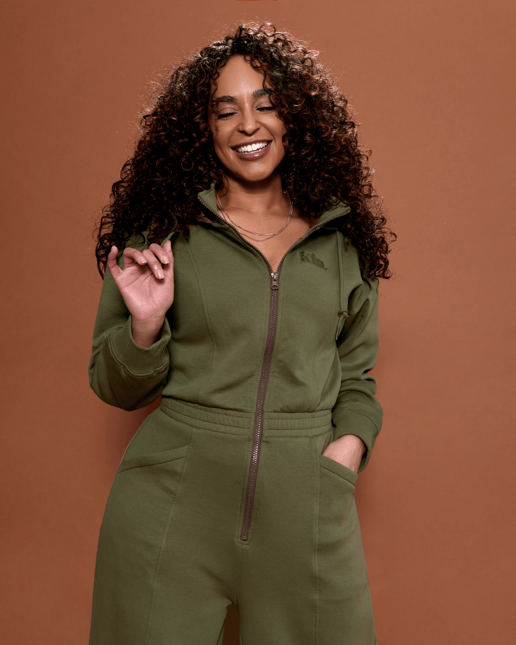 Green satin-lined jumpsuit by Plush Fashion Hub featuring a stylish, smooth fabric and a modern, fitted design.