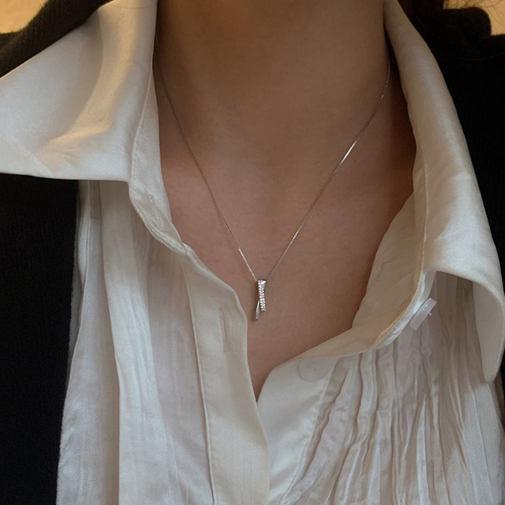 Sterling silver zircon pendant necklace with sparkling gemstone, elegant jewelry piece showcasing a shiny silver chain and detailed pendant.