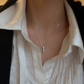 Sterling silver zircon pendant necklace with sparkling gemstone, elegant jewelry piece showcasing a shiny silver chain and detailed pendant.
