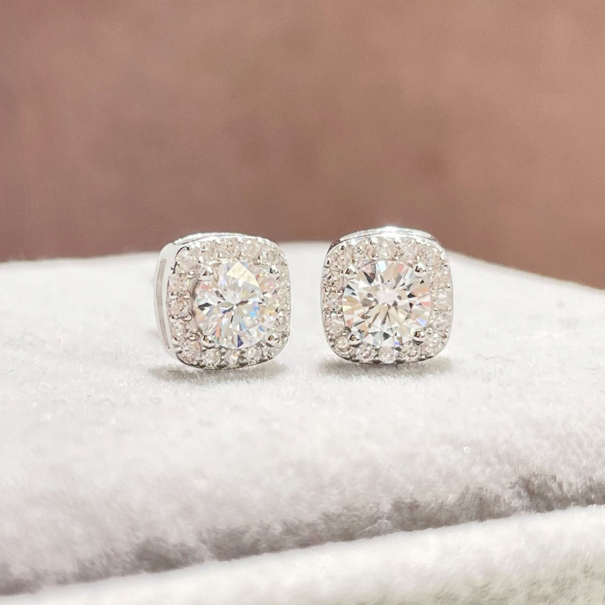 Sterling silver stud earrings with 1-carat moissanite gemstones, showcasing elegant round cut jewelry for women