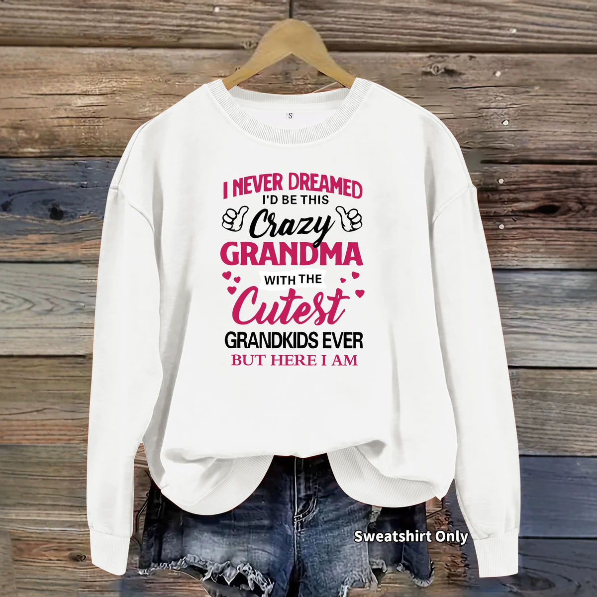 White crewneck sweatshirt with pink and black text reading "I never dreamed I'd be this crazy grandma..."