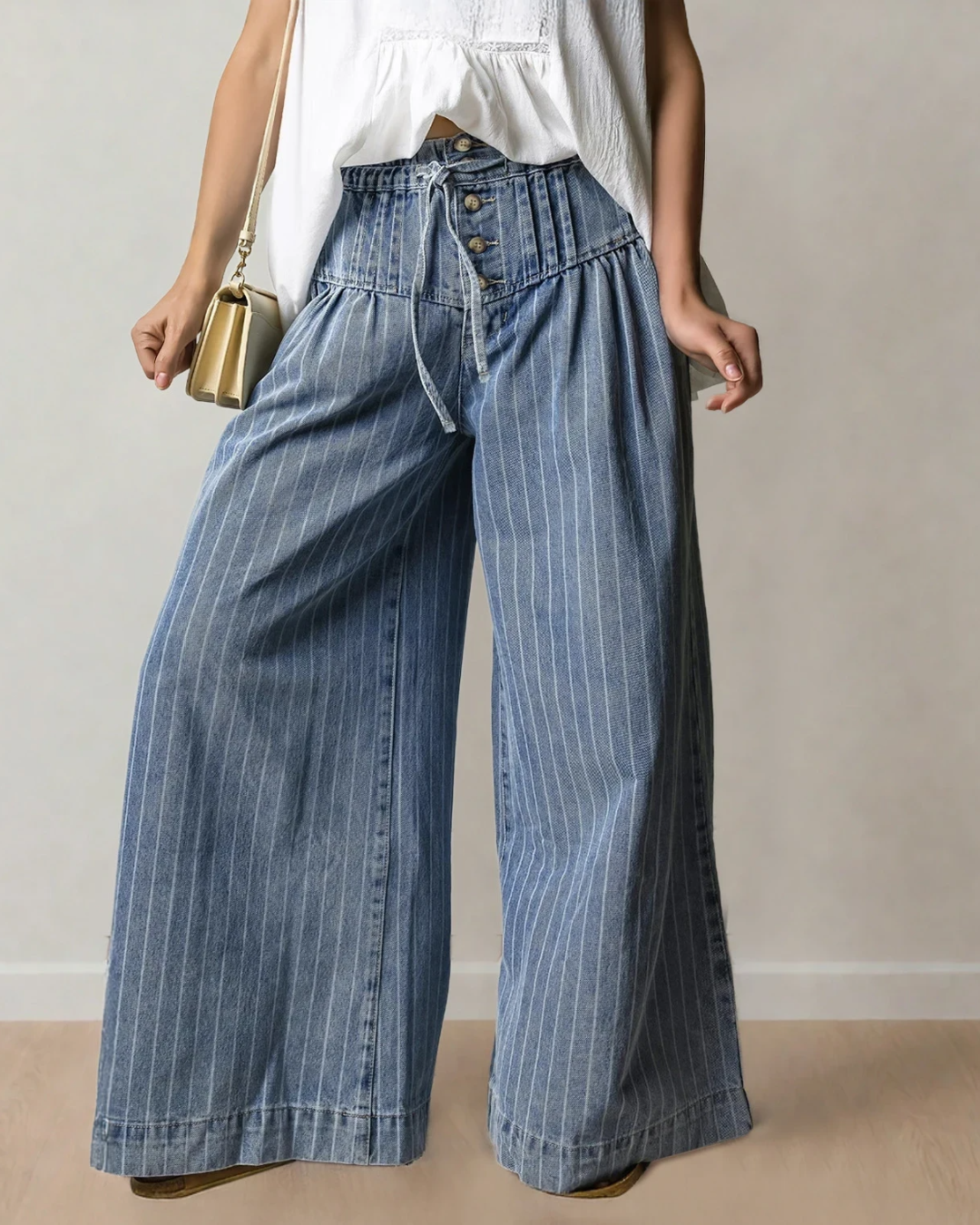 Blue striped wide-leg jeans featuring a buttoned waistband and a drawstring closure.