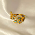 18K gold-plated resin leaf bypass ring with delicate overlapping design, showcasing a nature-inspired jewelry piece.