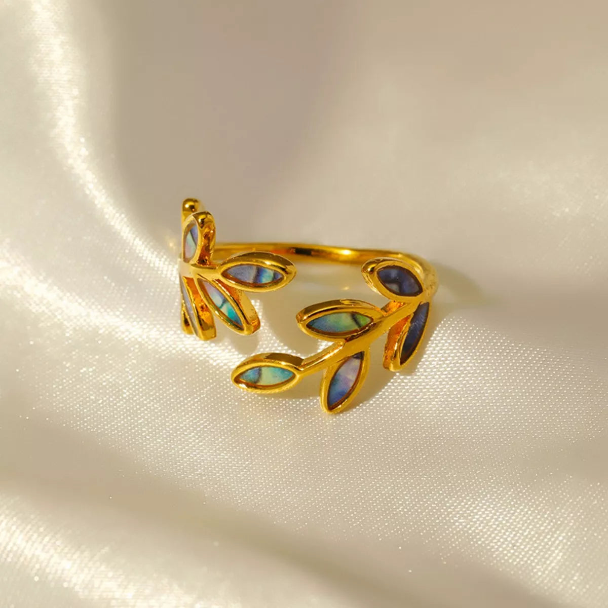 18K gold-plated resin leaf bypass ring with delicate design, showcasing intricate leaf patterns on a stylish jewelry piece.