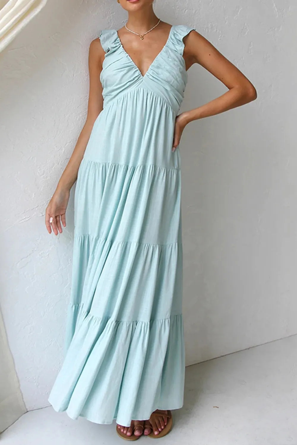 Women's cotton ruffled V-neck tiered midi dress featuring flowy fabric and ruffle details, perfect for casual or summer wear.