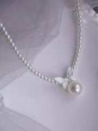 Pearl butterfly pendant necklace by Shopimist featuring a delicate pearl butterfly charm on a silver chain.