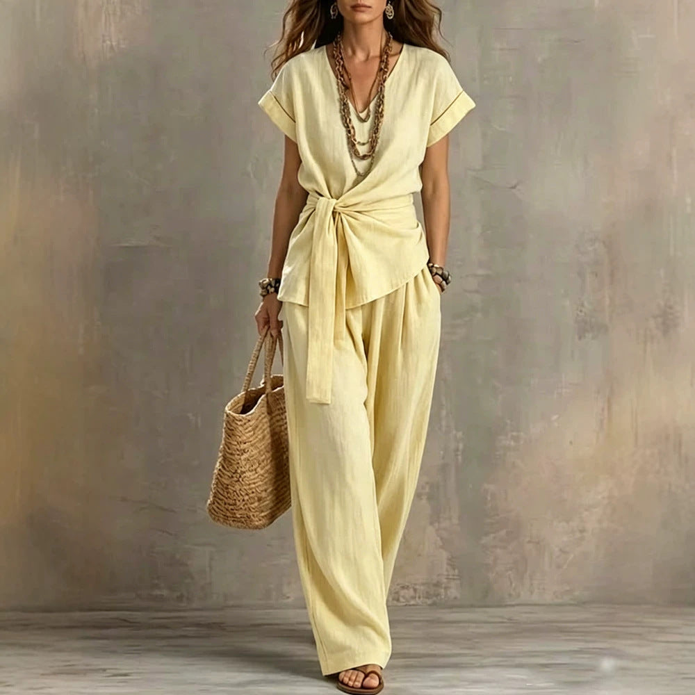 Women's V-neck short-sleeve top and matching pants two-piece set by Plush Fashion Hub, shown in a stylish, coordinated outfit.