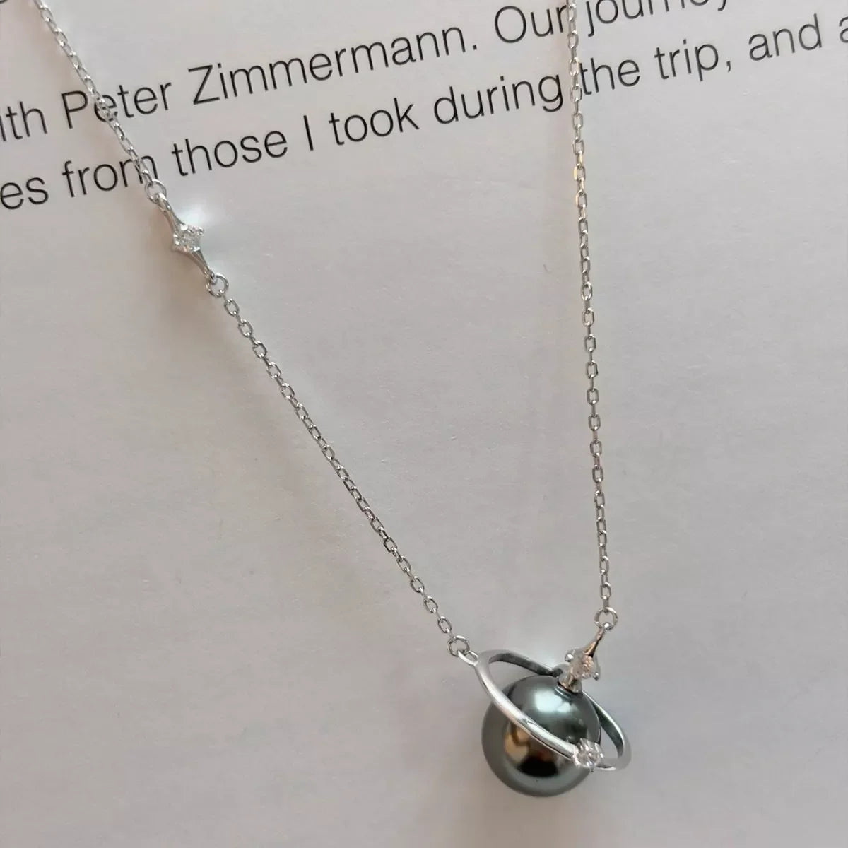 Planet Pearl Pendant Necklace by Shopimist featuring a shimmering pearl pendant on a delicate chain.