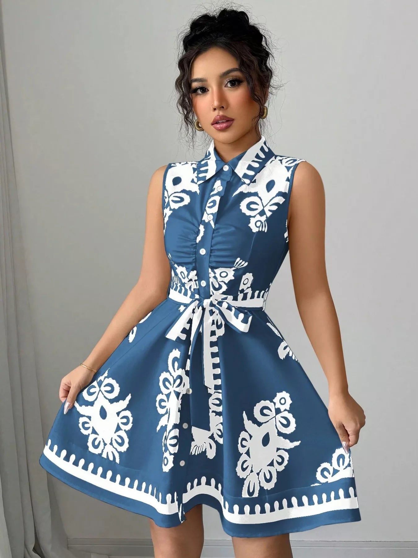 Sleeveless ruched printed tie waist dress by Shopimist, featuring a stylish pattern and flattering silhouette.
