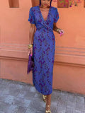 Women's ruched maxi dress by FitiqueFit featuring a V-neck, short sleeves, and a form-fitting printed elegant design.