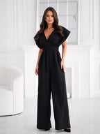 Shopimist surplice wide-leg jumpsuit with V-neck, long sleeves, and flowy silhouette, shown in beige fabric.