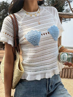 Openwork ruffled hem knit top from Trendsi featuring a stylish openwork design and feminine ruffled hem detail.