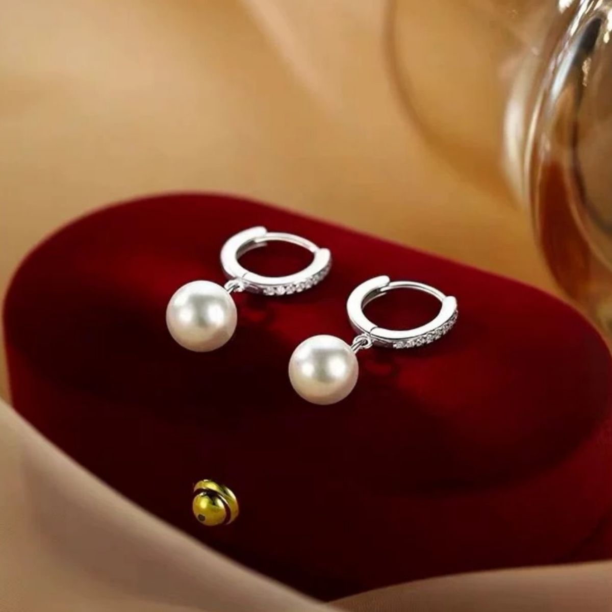 Pearl drop hoop earrings from Plush Fashion Hub featuring elegant gold hoops with dangling pearl accents.