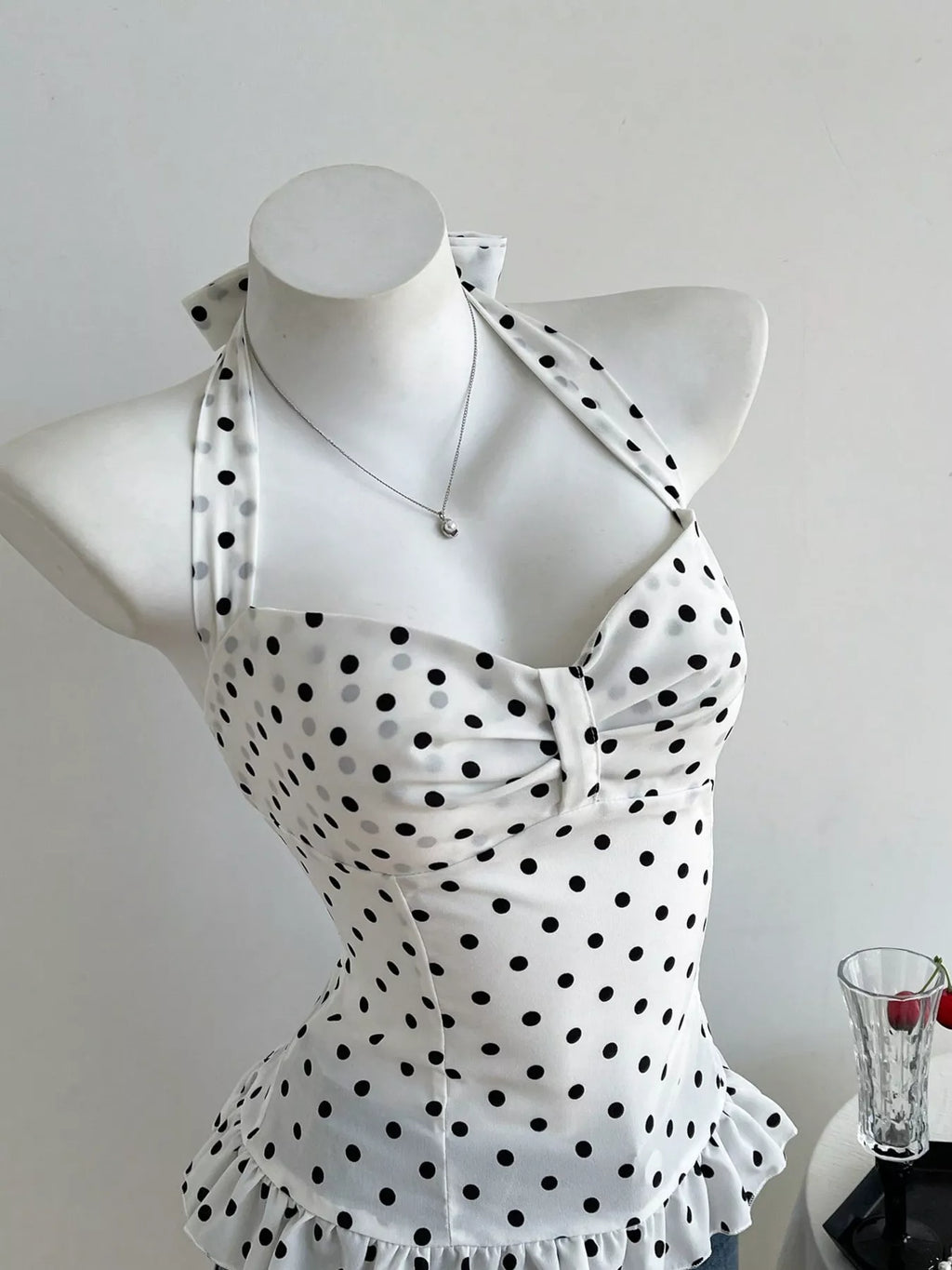 Polka dot halter neck cami top by Plush Fashion Hub featuring a stylish sleeveless design and playful polka dot pattern.