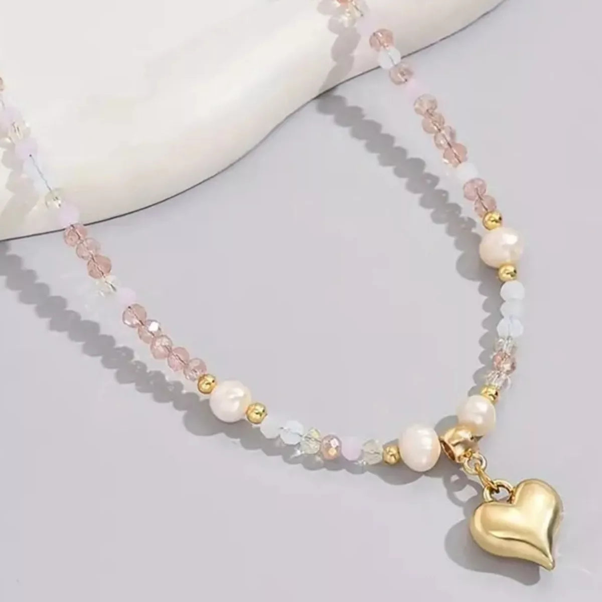 Bead heart pendant necklace from Plush Fashion Hub featuring a delicate heart-shaped beaded design on a necklace chain.