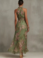 Plus size floral print sleeveless maxi dress from Trendsi, showing a full-length view of the colorful, flowy dress on a model.