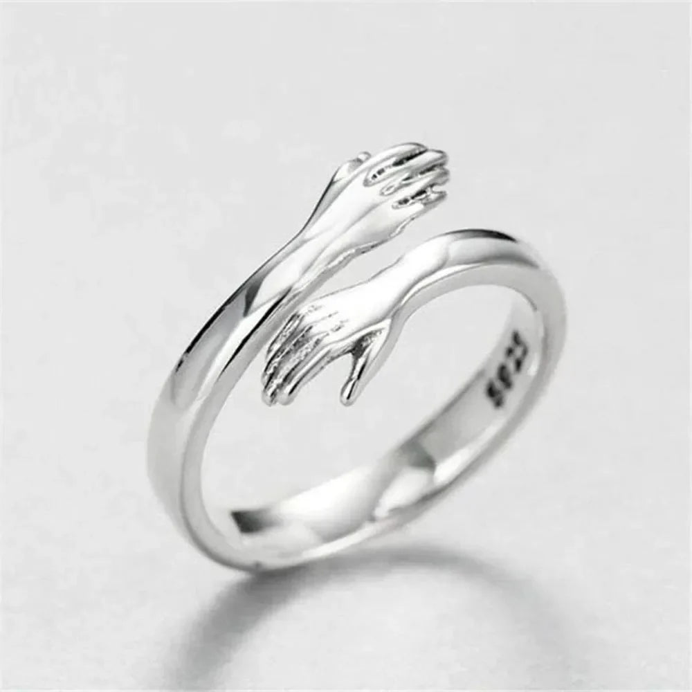 Sterling silver Hug Shape bypass ring with smooth, curved design, crafted by Plush Fashion Hub, showcasing its shiny, polished finish.