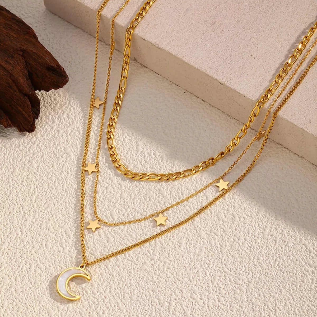 Gold-plated three-layered moon necklace from Plush Fashion Hub featuring delicate chain and moon pendant details.