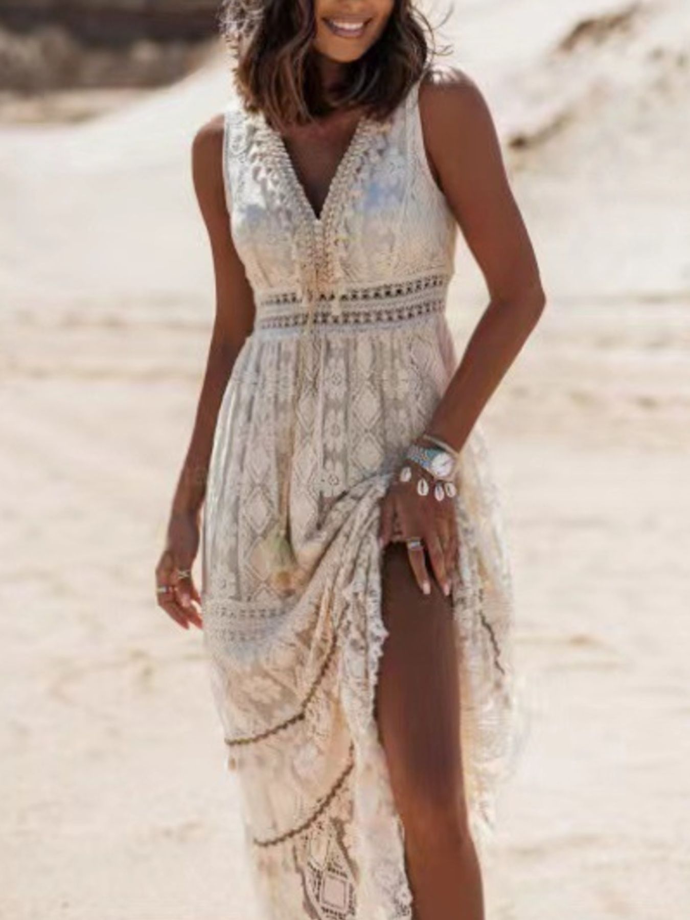 Ethereal V-neck lace sleeveless maxi dress with tassel accents, flowing fabric, and elegant design from Trendsi.