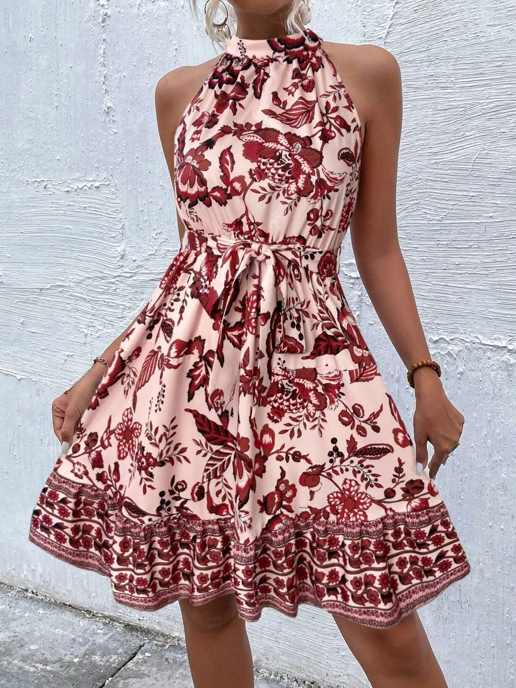 Printed sleeveless tie waist dress by Shopimist, featuring a stylish design with a fitted waist and vibrant pattern.