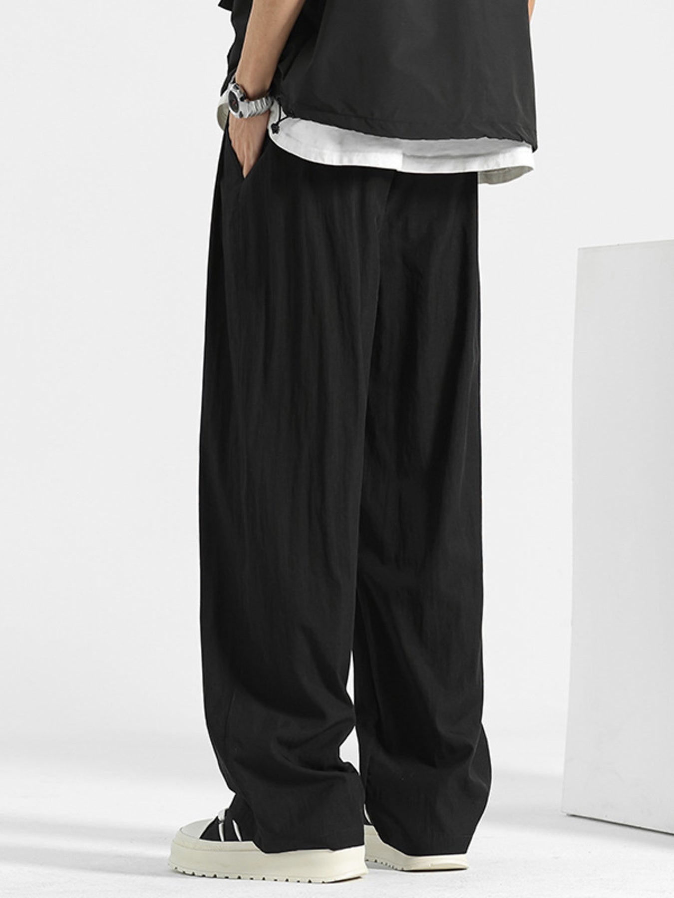 Men's loose fit casual pants with drawstring waist by Trendsi, relaxed fit trousers suitable for everyday comfort.