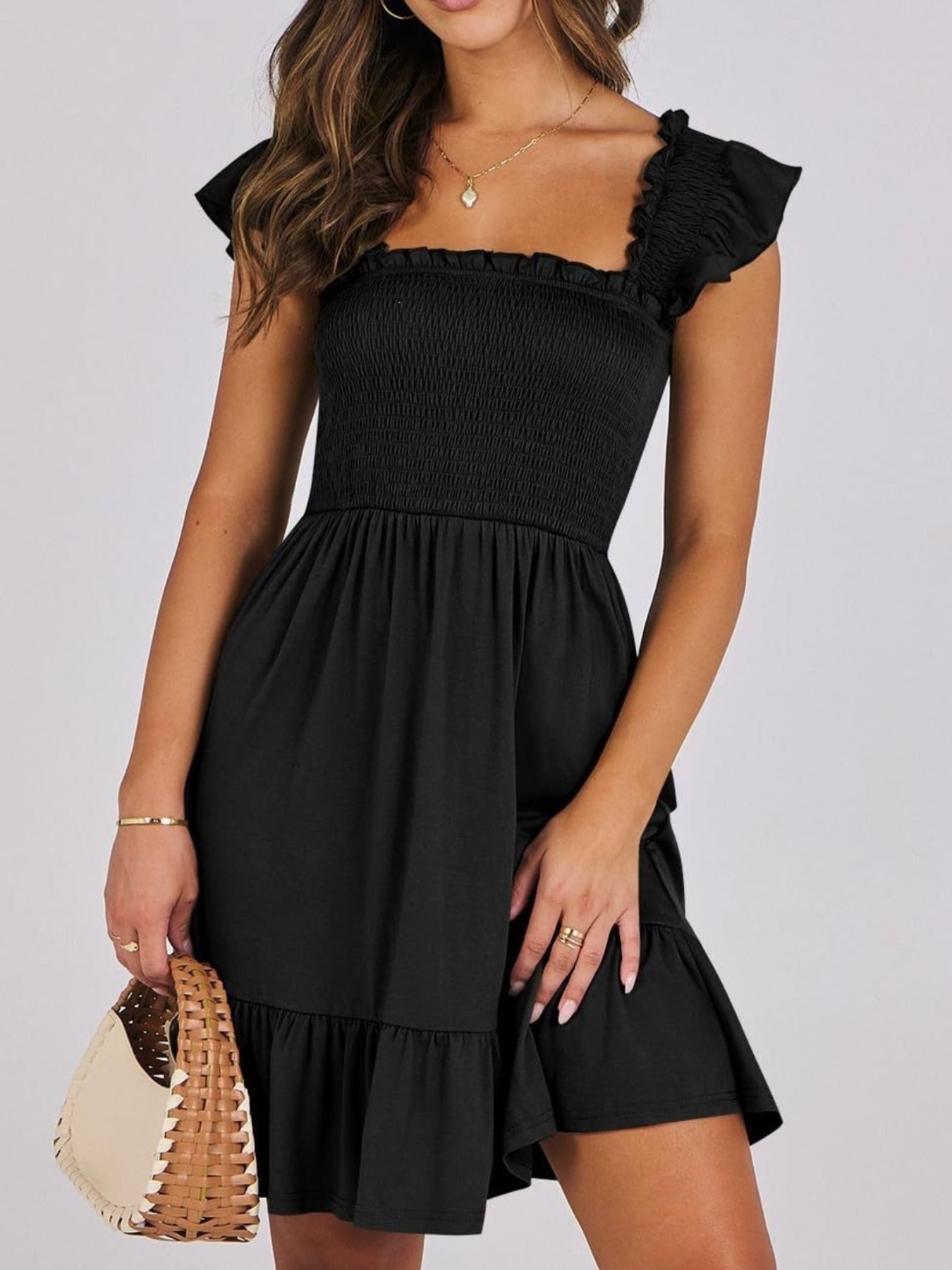 Women's smocked ruffle hem mini dress by Trendsi, lightweight casual summer dress with flowy fabric and ruffle details.