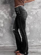 Distressed flare denim jeans by Plush Fashion Shop featuring a high-waist fit and ripped details for a trendy casual look.