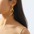 Shopimist alloy spiral drop earrings with sleek, curved design hanging from earlobes, showcasing modern jewelry style.