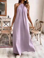 Elegant black halter neck maxi dress by Shopimist featuring a flowing silhouette and open back design.