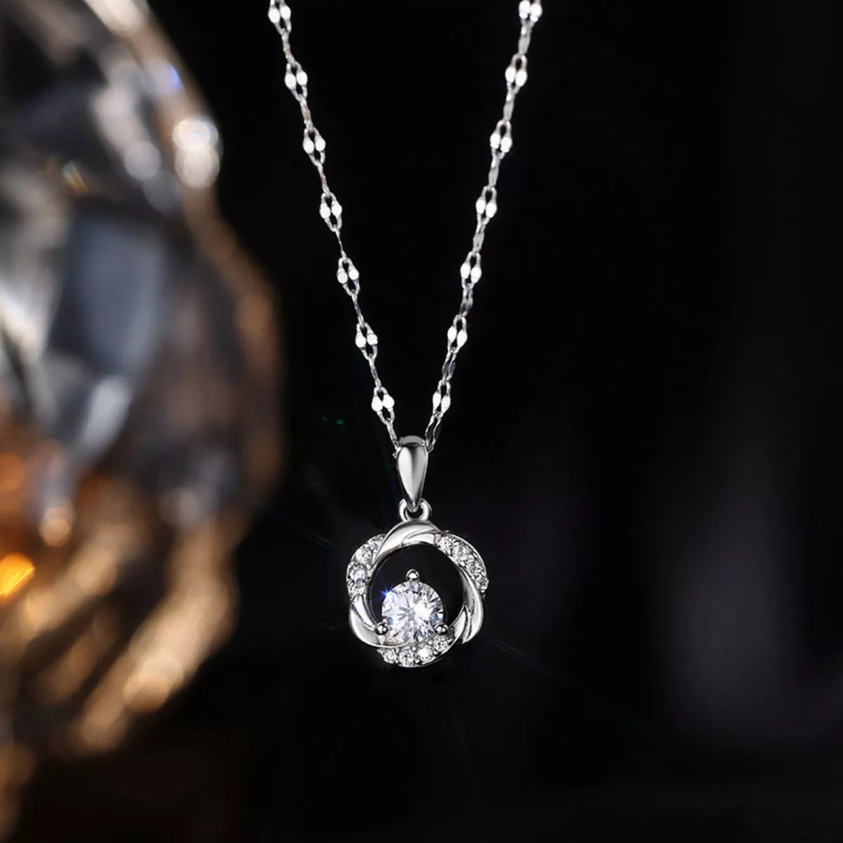 Sterling silver zircon pendant necklace with intricate design, showcasing sparkling stones and a delicate chain.
