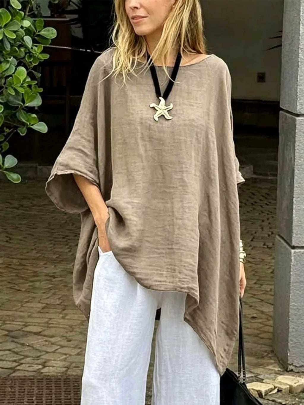 Plus size loose fit asymmetrical hem tunic top by Trendsi, shown in natural fabric with a flowing, relaxed fit and stylish asymmetrical hem.