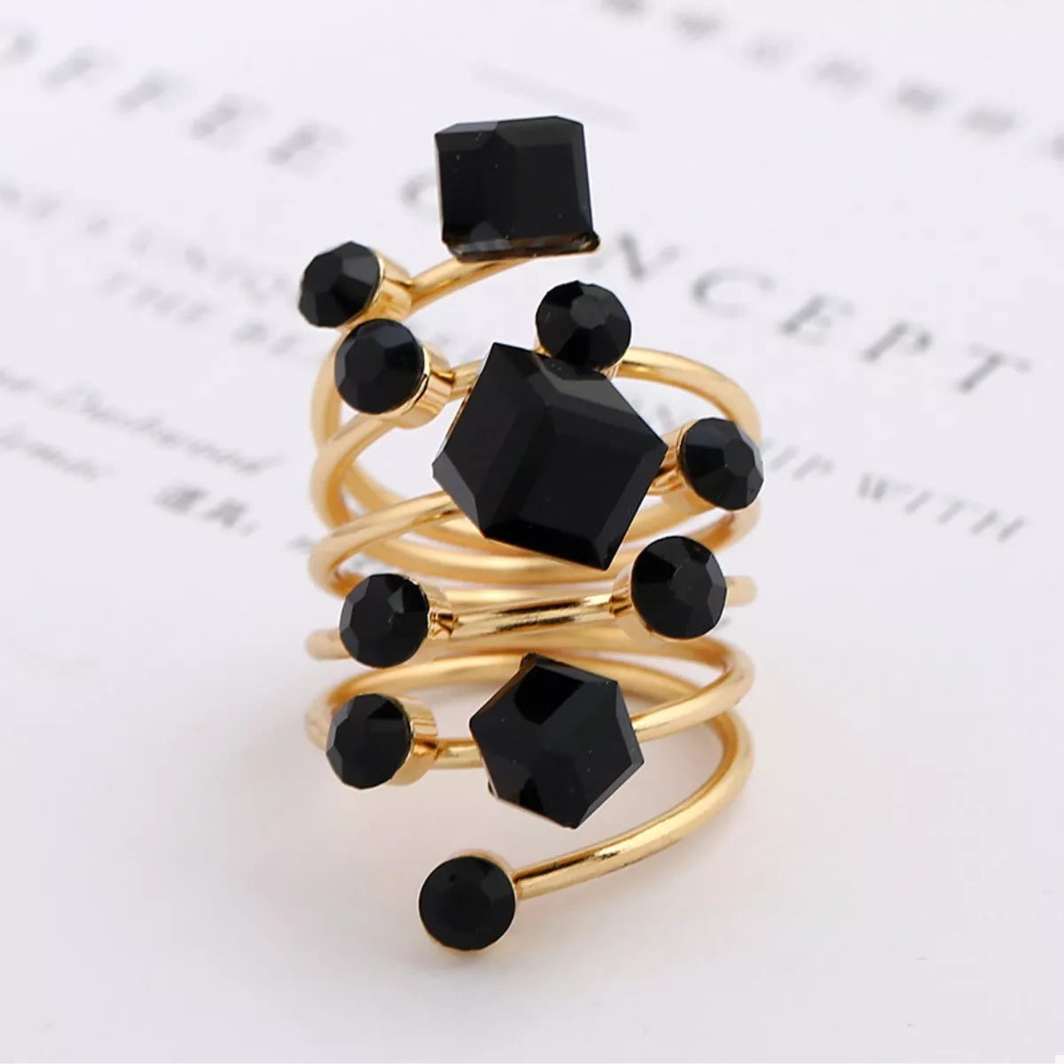 18K gold-plated multi-layered ring featuring stacked band design, showcasing shiny gold finish and intricate detailing.