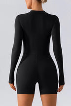 Trendsi half-zip long sleeve active romper in sleek athletic fabric, designed for active wear and movement.