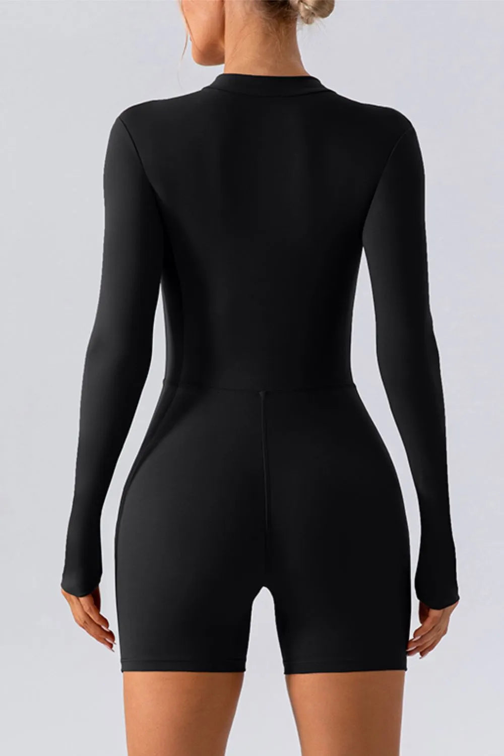 Trendsi half-zip long sleeve active romper in sleek athletic fabric, designed for active wear and movement.