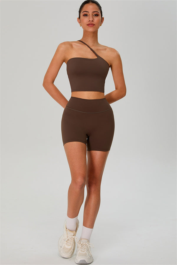 Fitglutes activewear one-shoulder crop top and matching shorts 2-piece set for workout and gym wear, shown in black fabric.
