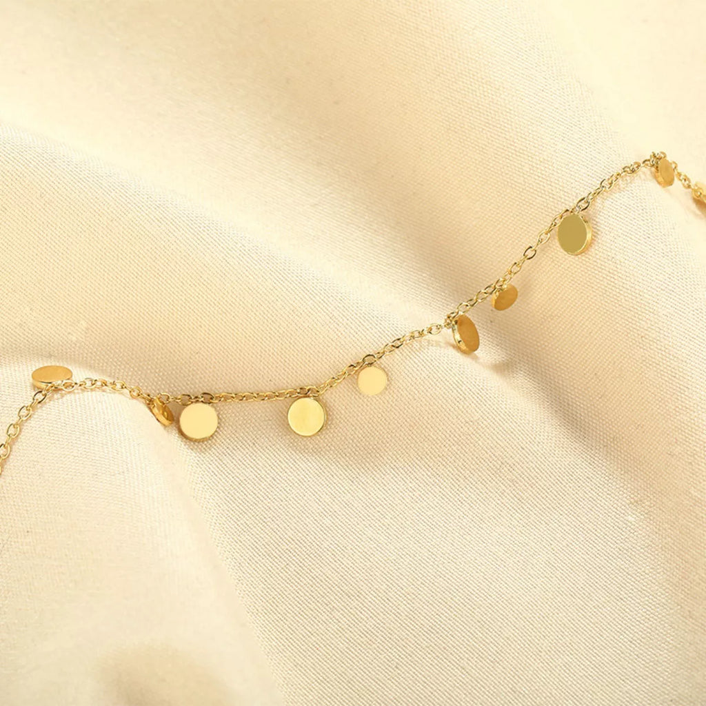 Gold-plated charm bracelet with decorative charms, 18K gold finish, stylish jewelry accessory by Shopimist