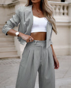 Women's striped spring fashion suit by Plush Fashion Hub, featuring a cropped long sleeve top and straight pants.